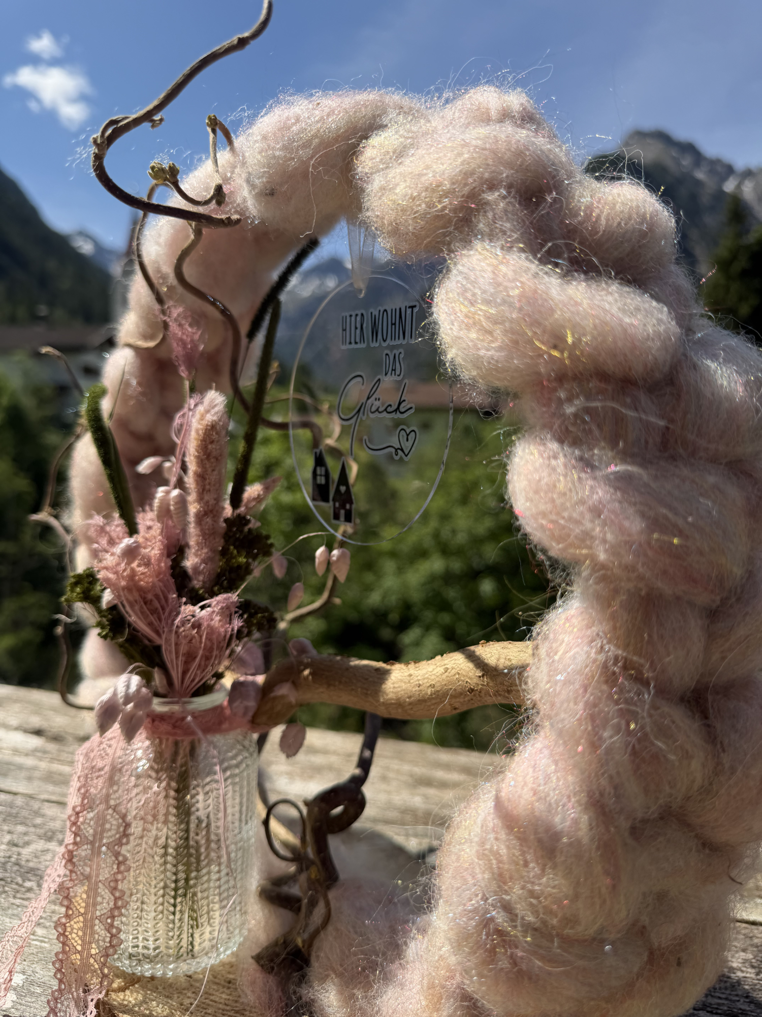 Dekoring „Rosalie" aus Schurwolle mit Trockenblumen vor Lechtaler Bergpanorama